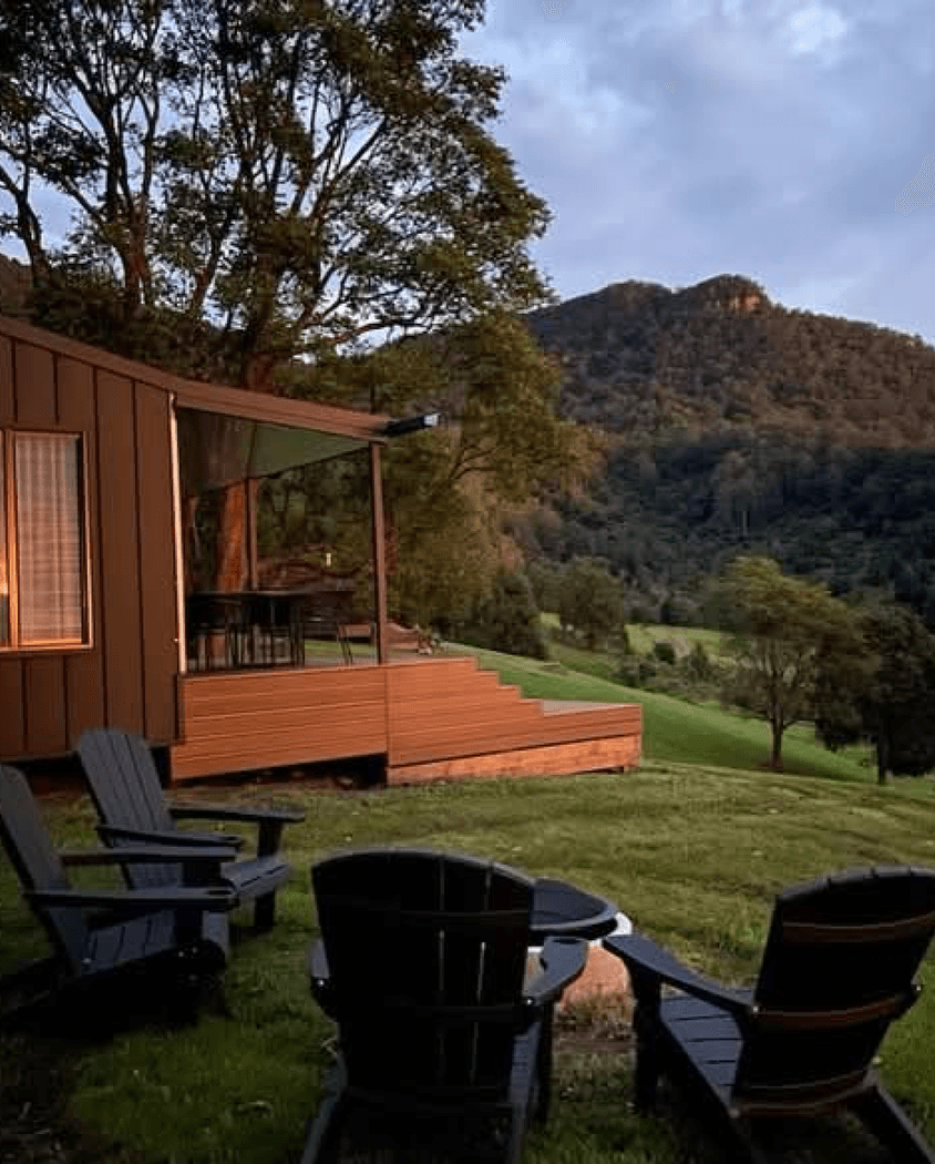 Modern wooden building nestled in natural mountain setting